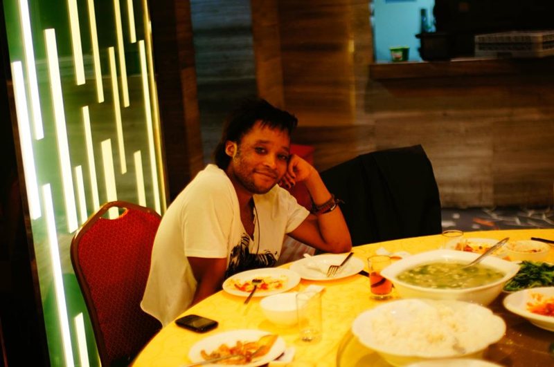 Aldrich at a table full of Chinese food